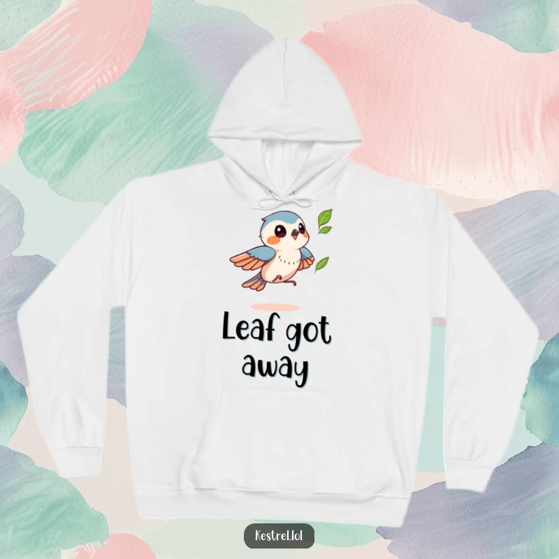Funny kestrel hoodie showing a bird playfully chasing a leaf, symbolizing autumn joy, a warm and humorous gift.