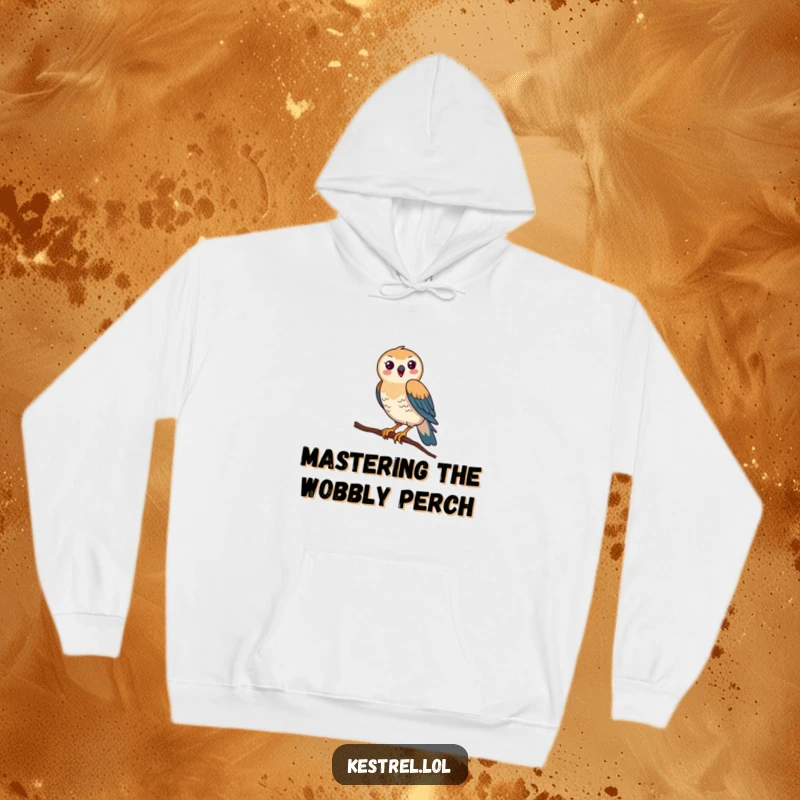 Funny Kestrel Hoodie: A happy kestrel comically tries to keep its balance on a very thin branch, looking utterly ridiculous and charming.