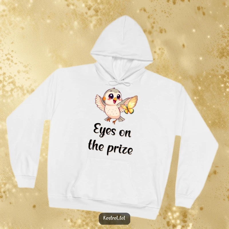 Funny hoodie depicting a happy kestrel with big eyes playfully chasing a shimmering butterfly in a charming scene.
