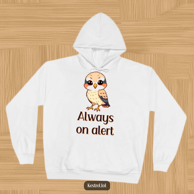 Funny kestrel hoodie featuring a cheerful bird with sharp eyes, scanning the ground with focus.