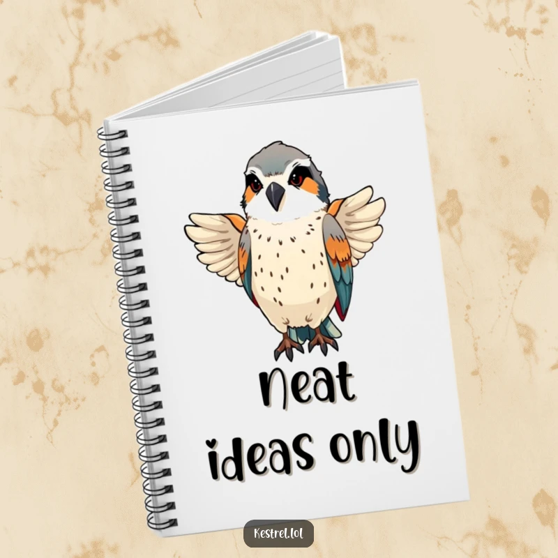 Funny kestrel preens sleek feathers with a proud, focused expression on a functional notebook.