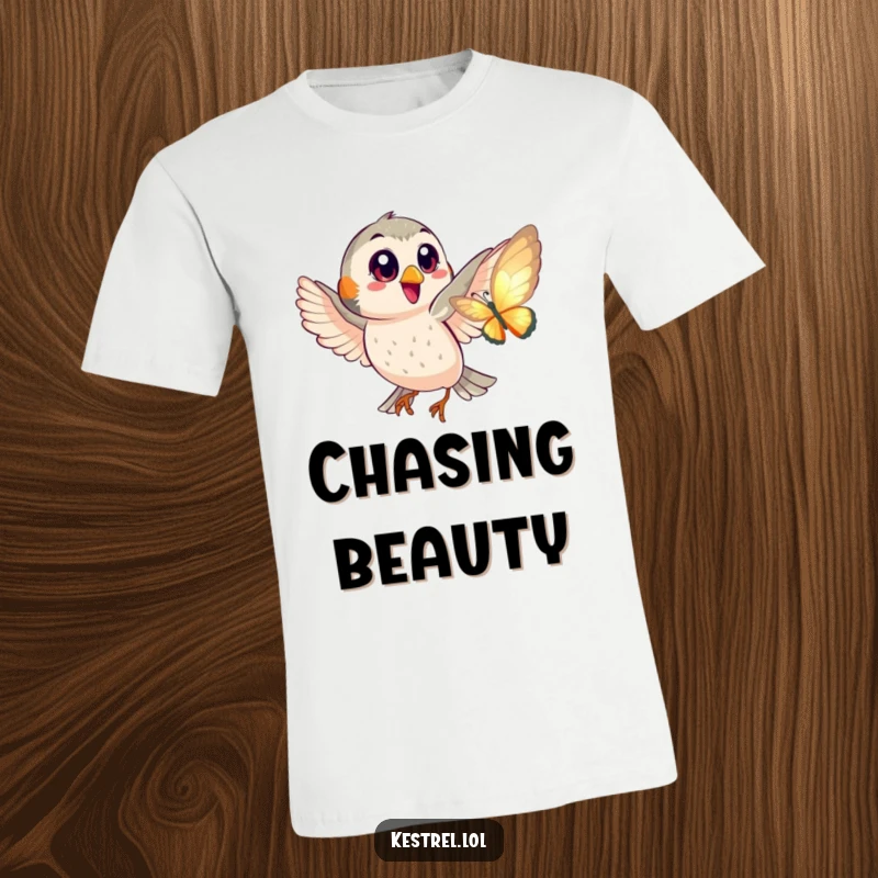 Funny t-shirt graphic of a happy kestrel with big eyes playfully chasing a shimmering butterfly in a lighthearted pursuit.