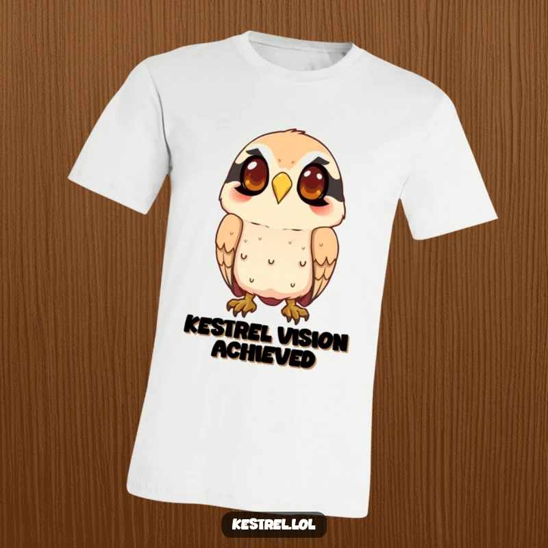 Funny kestrel t-shirt featuring a smiling character intently watching from above, ideal for casual wear and showcasing keen observation.