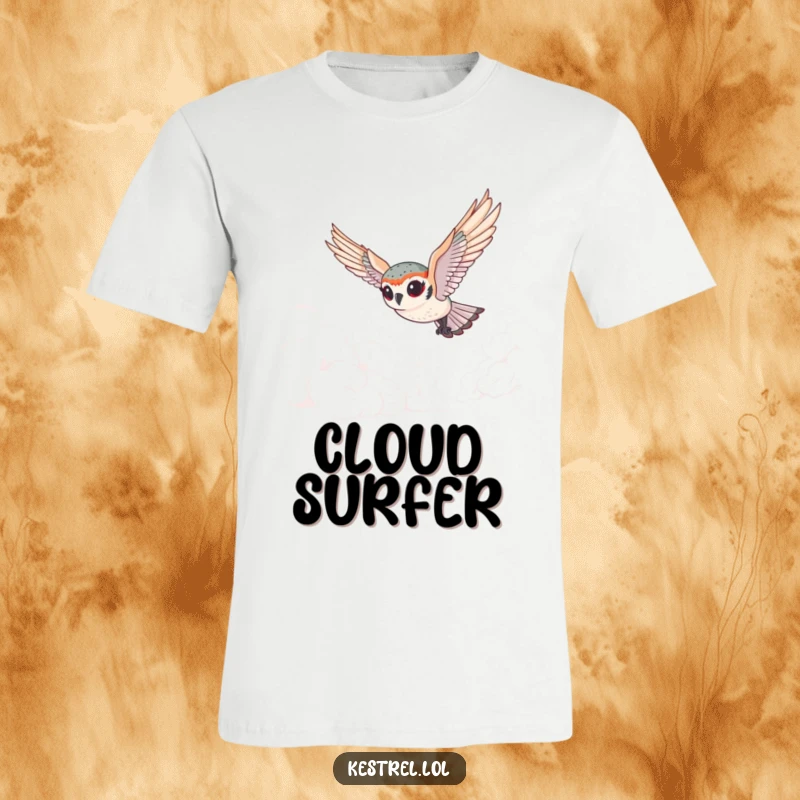 Funny tiny kestrel t-shirt with exaggerated eyes gracefully diving through fluffy clouds, showcasing a humorous and whimsical vibe.