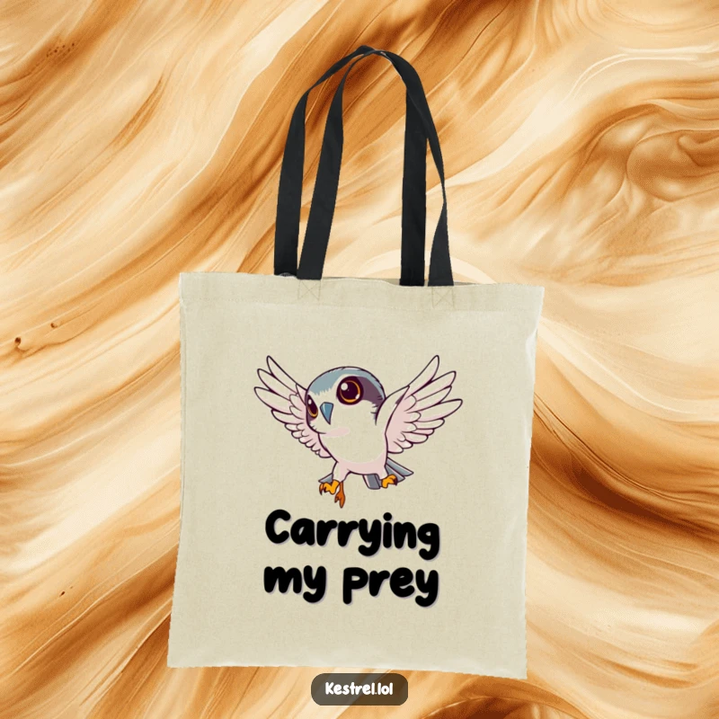 Funny kestrel tote bag featuring a determined kestrel character in a sharp, downward dive, adding a humorous and focused touch to your carryall.