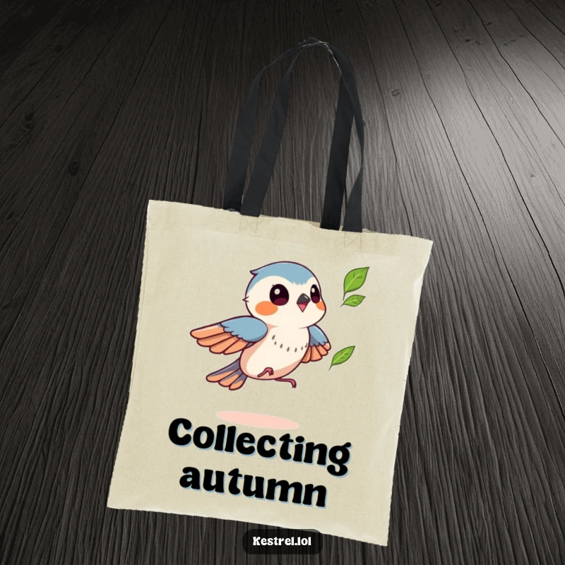Funny kestrel tote bag depicting a bird playfully chasing a fluttering leaf, a humorous and practical autumn accessory gift.