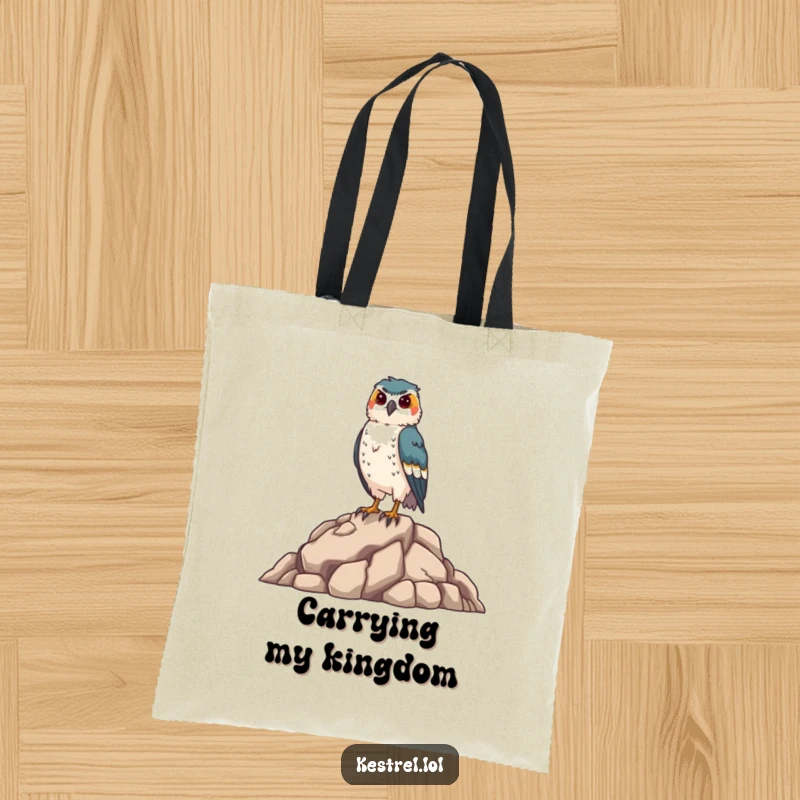Funny kestrel tote bag depicting a proud falcon standing on rocks, ideal for carrying groceries or books, a humorous and practical bird gift.